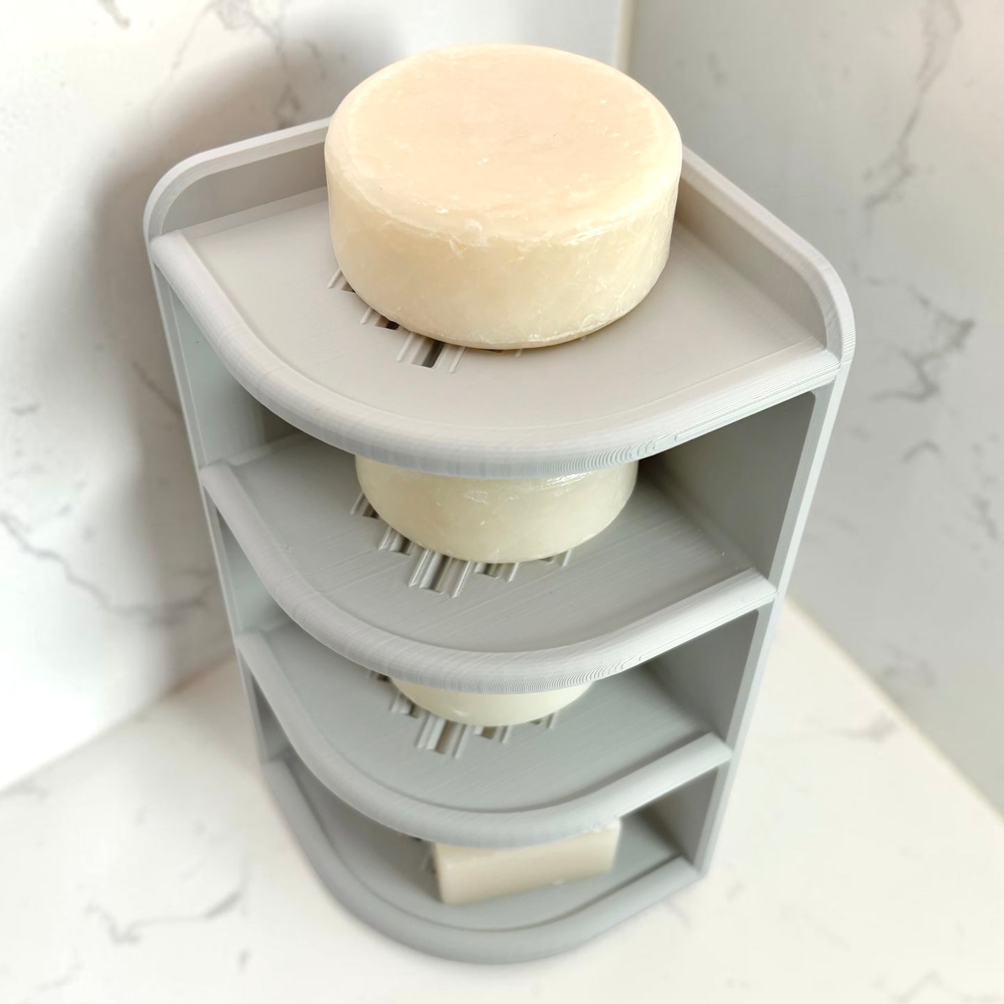 Gray corner shelf with soap on a marble background