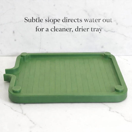 Green plastic tray with a subtle slope on a white background
