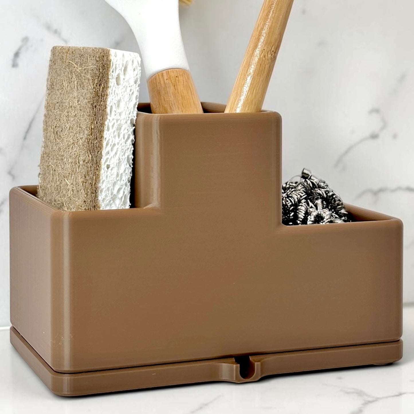 Brown utensil holder with kitchen tools on a marble surface