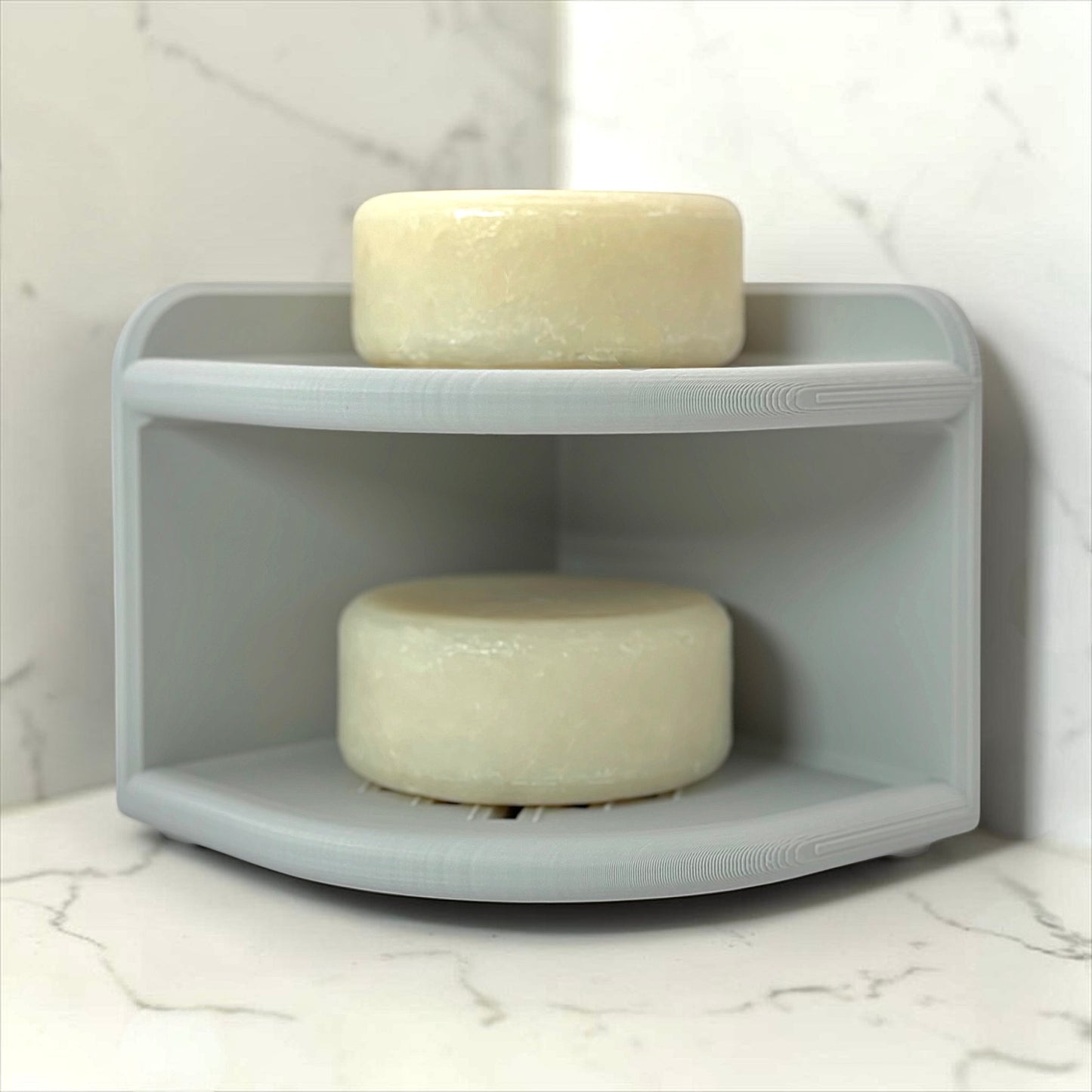Light Gray corner shelf soap holder with two bars on a marble surface