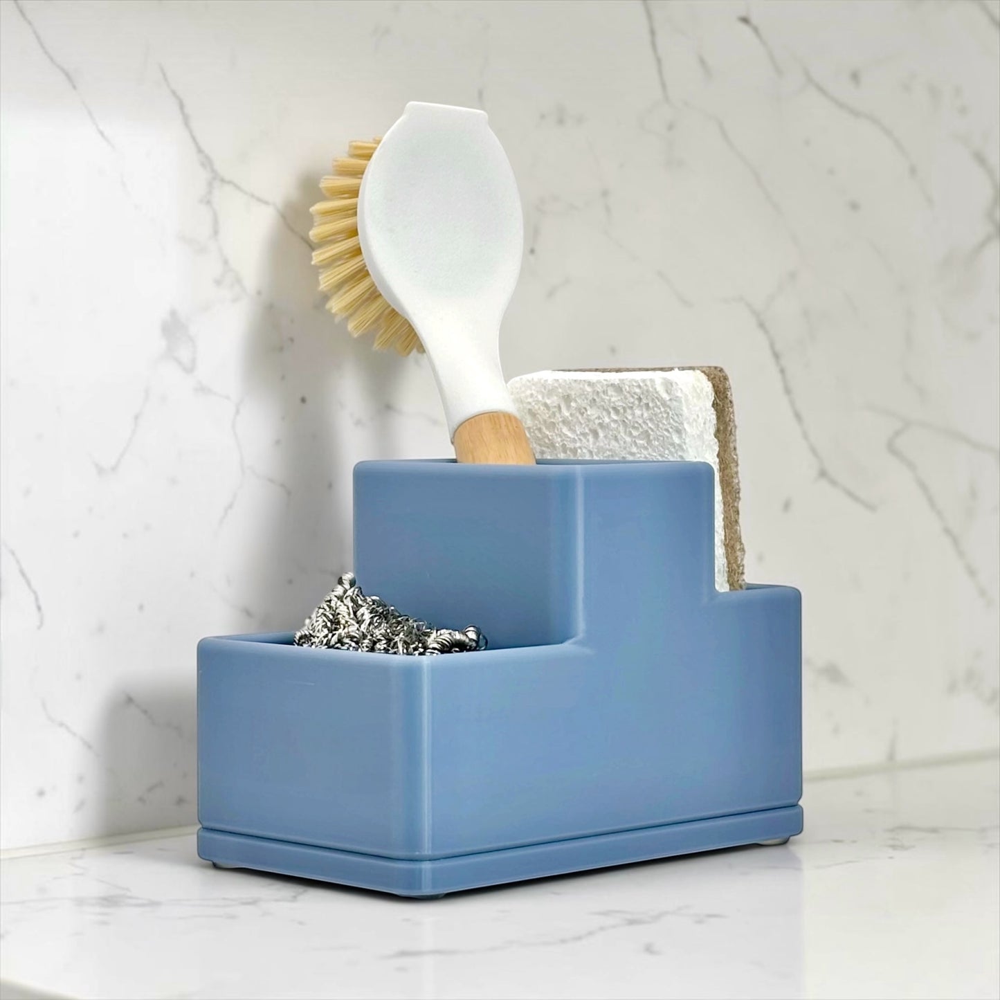 Blue holder with cleaning tools on a marble surface