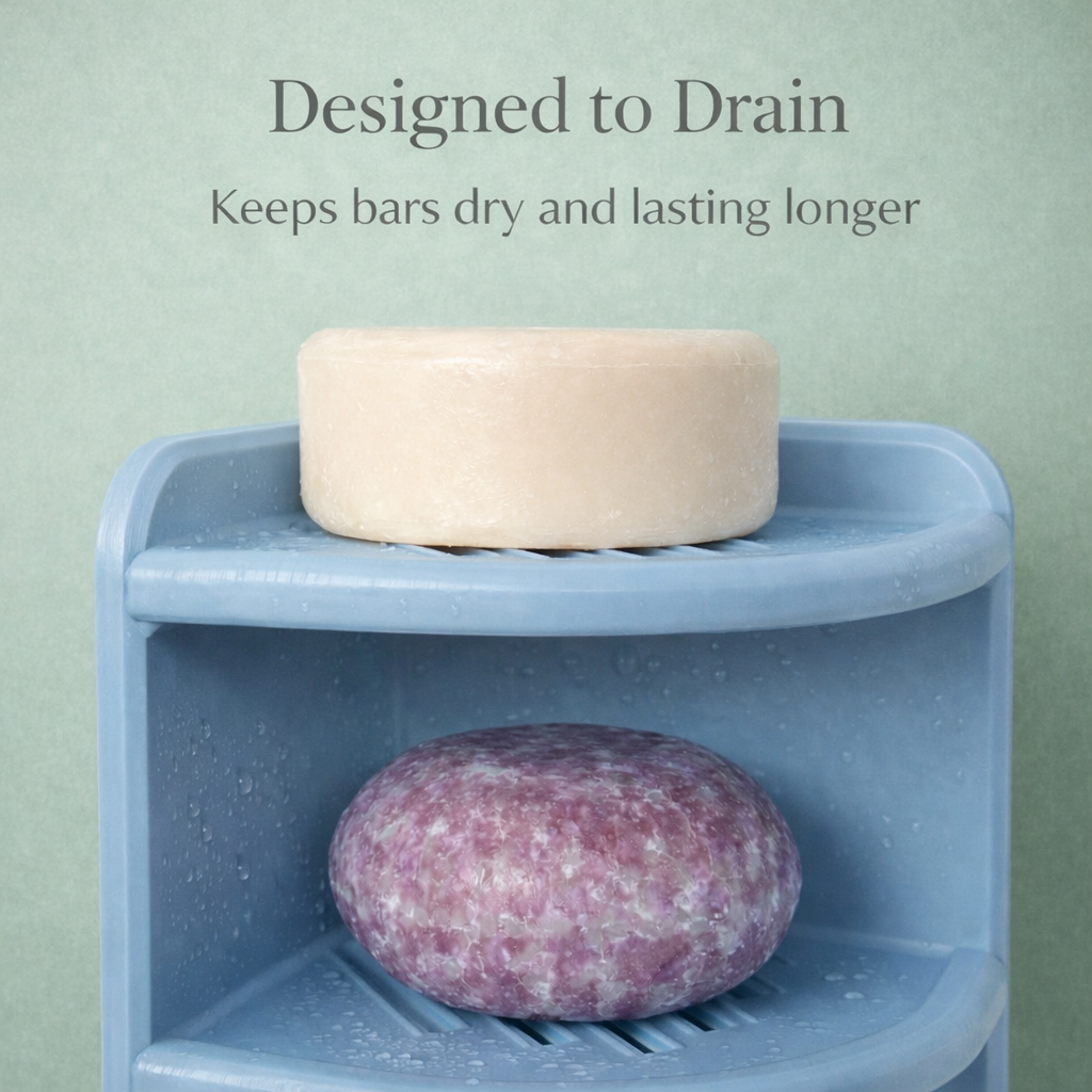 Blue soap dish with a beige bar of soap and a pink soap bar on a light green background.