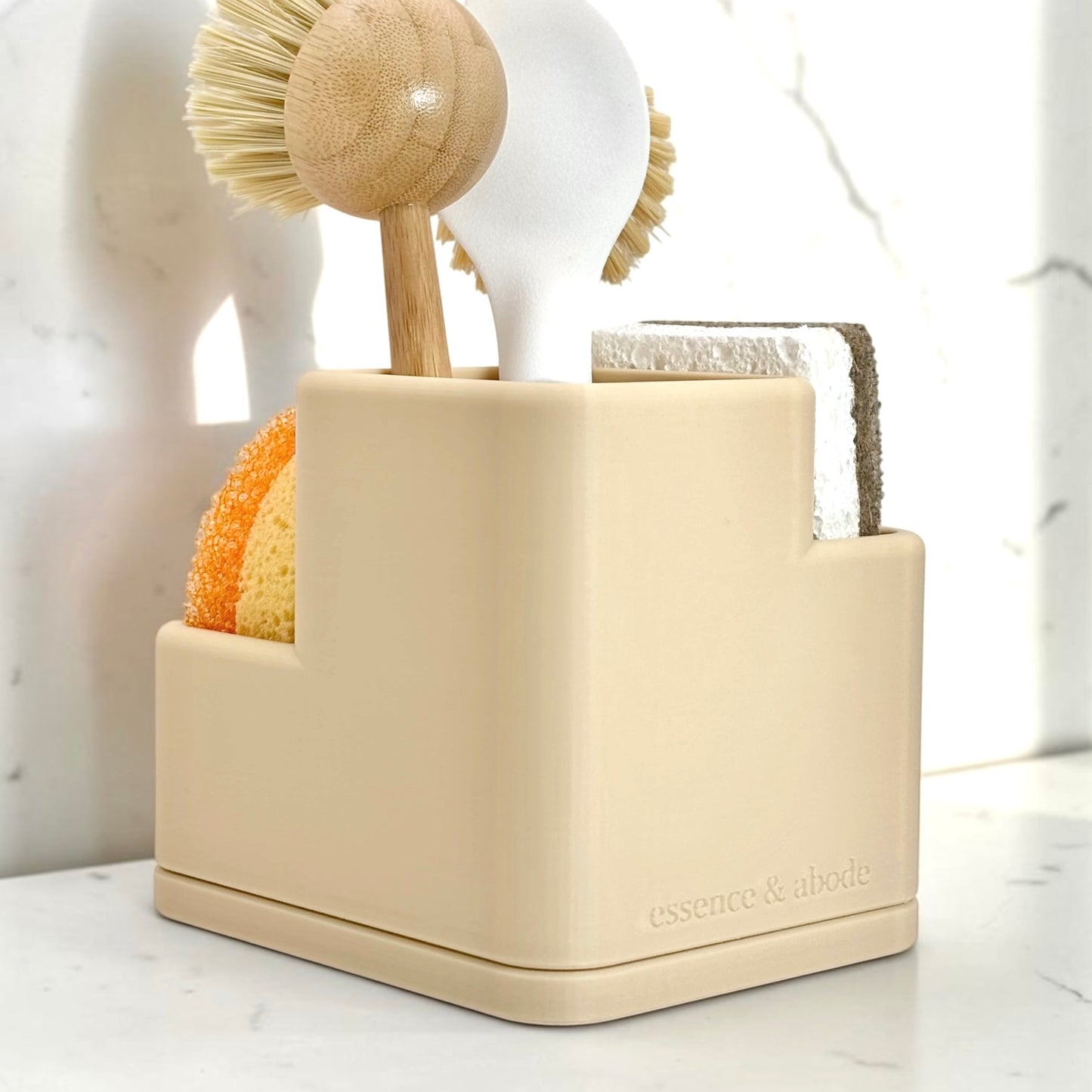 Beige cleaning tool holder with various cleaning tools on a marble surface