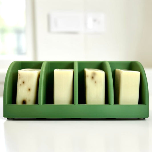 olive green soap holder with four bars of soap on a white surface