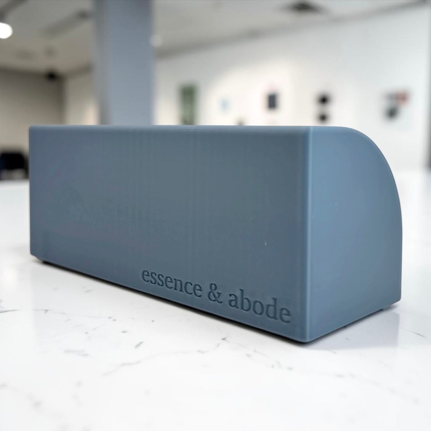 misty blue soap holder back part shown with 'essence & abode' branding on a white floor.