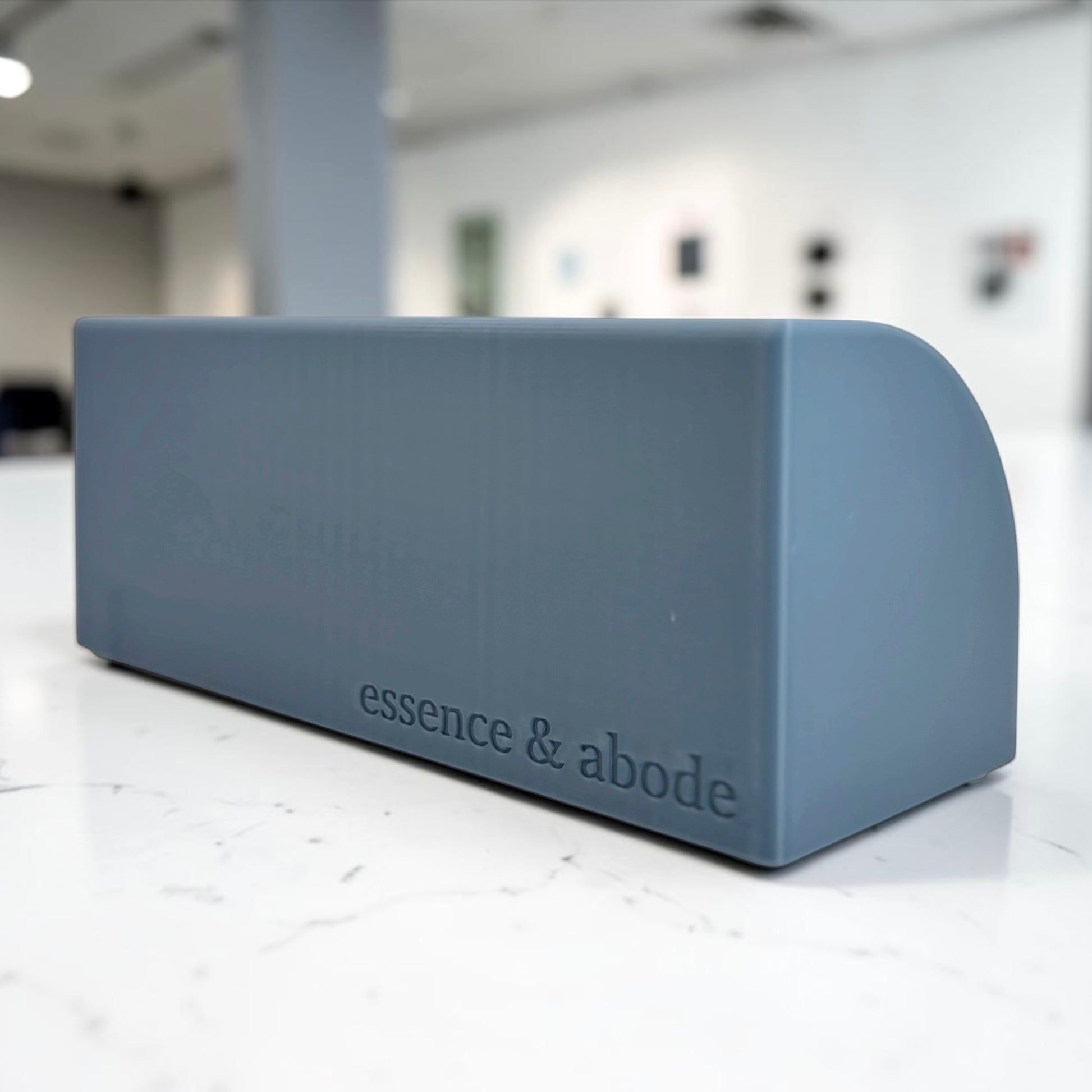misty blue soap holder back part shown with 'essence & abode' branding on a white floor.