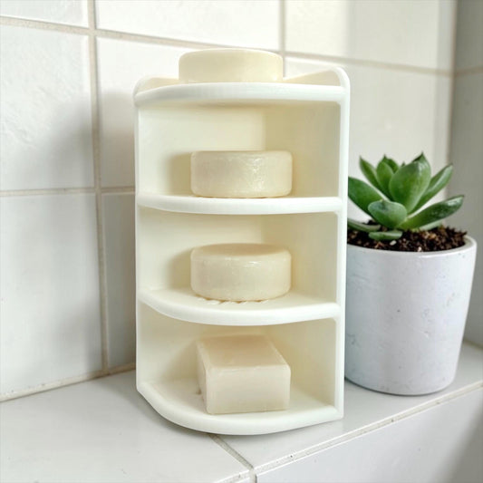 Corner shelf with soap bars on a tiled bathroom wall