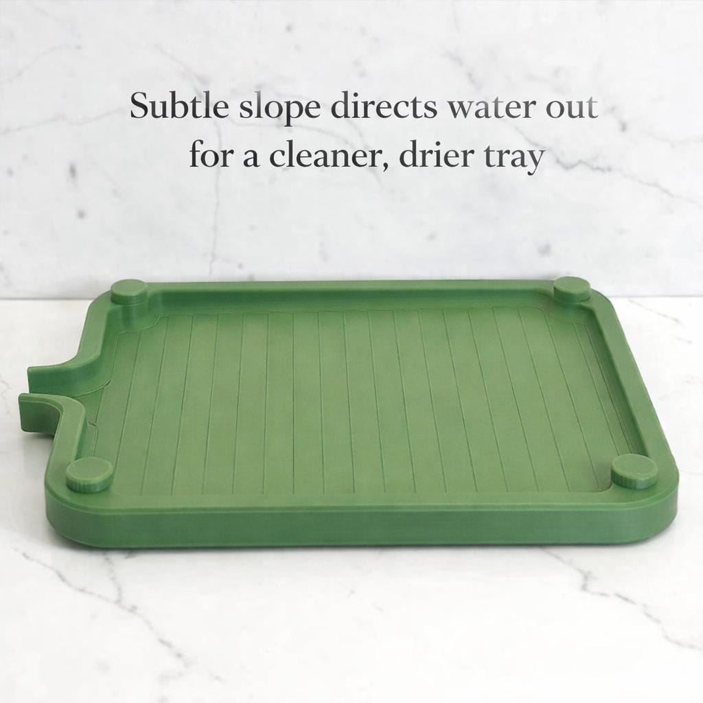Green plastic tray with a subtle slope on a white background