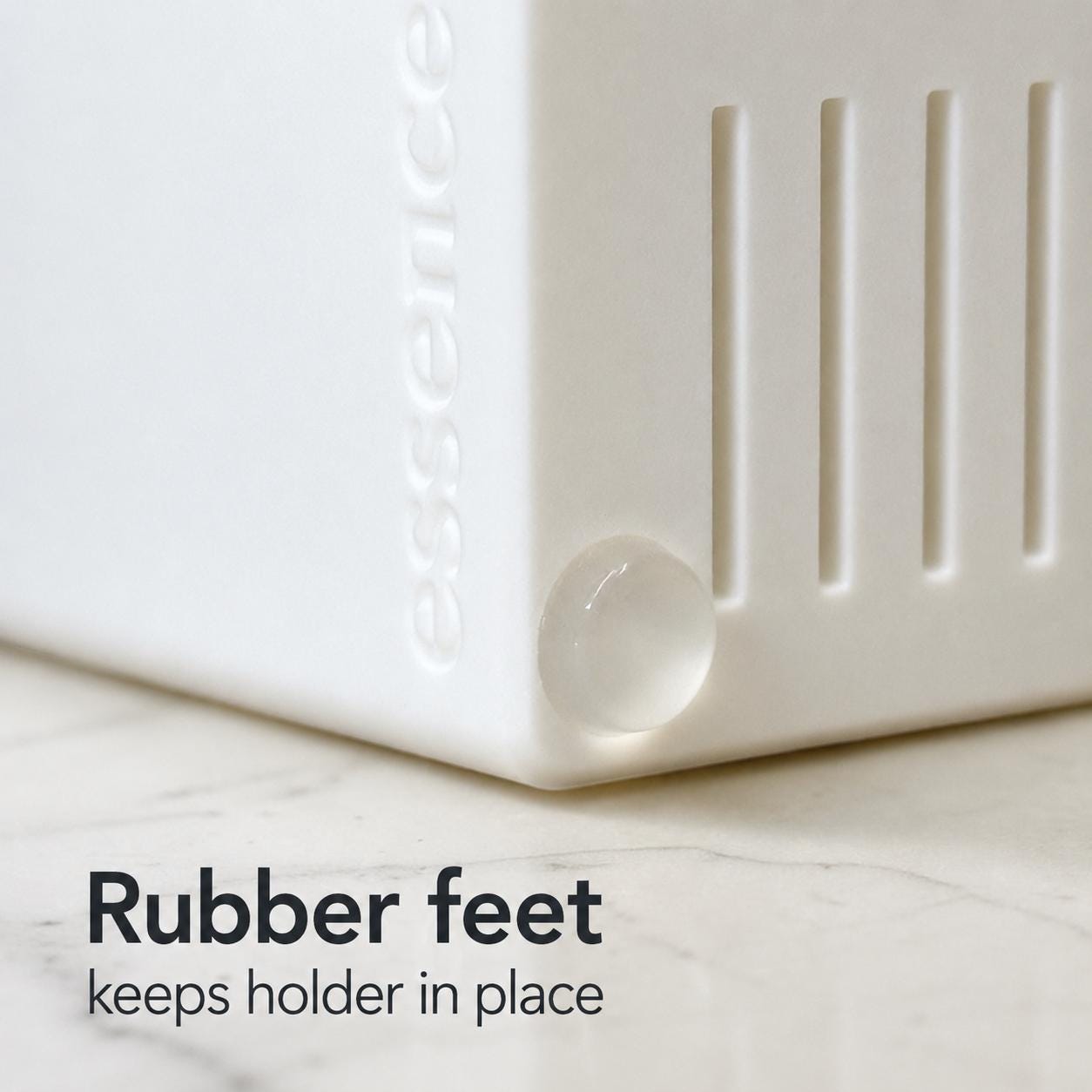White holder with rubber feet on a marble surface, texts indicating rubber feet keeps holder in place